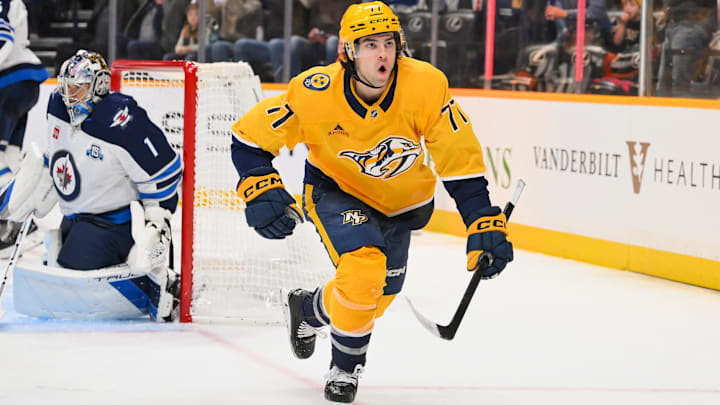 Nov 29, 2025; Nashville, Tennessee, USA;  Nashville Predators right wing Luke Evangelista (77) reacts after scoring a goal against Winnipeg Jets goaltender Eric Comrie (1) during the third period at Bridgestone Arena. 