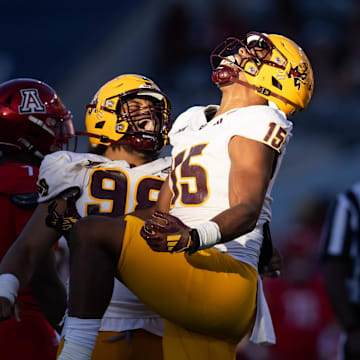 Nov 30, 2024; Tucson, Arizona, USA; Arizona State Sun Devils defensive lineman Elijah O'Neal (15) celebrates with Jacob Rich Kongaika (98) against the Arizona Wildcats in the second half during the Territorial Cup at Arizona Stadium. Mandatory Credit: Mark J. Rebilas-Imagn Images