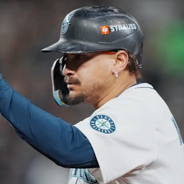 Oct 16, 2025; Seattle, Washington, USA; Seattle Mariners first baseman Josh Naylor (12) reacts after hitting a single against the Toronto Blue Jays in the fourth inning during game four of the ALCS round for the 2025 MLB playoffs at T-Mobile Park. Mandatory Credit: Stephen Brashear-Imagn Images