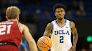 Nov 3, 2025; Los Angeles, California, USA;  UCLA Bruins guard Donovan Dent (2) dribbles the ball against Eastern Washington Eagles guard Johnny Radford (21) during the second half at Pauley Pavilion presented by Wescom Financial. Mandatory Credit: Kiyoshi Mio-Imagn Images