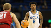 Nov 3, 2025; Los Angeles, California, USA;  UCLA Bruins guard Donovan Dent (2) dribbles the ball against Eastern Washington Eagles guard Johnny Radford (21) during the second half at Pauley Pavilion presented by Wescom Financial. Mandatory Credit: Kiyoshi Mio-Imagn Images