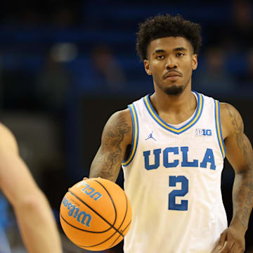 Nov 3, 2025; Los Angeles, California, USA;  UCLA Bruins guard Donovan Dent (2) dribbles the ball against Eastern Washington Eagles guard Johnny Radford (21) during the second half at Pauley Pavilion presented by Wescom Financial. Mandatory Credit: Kiyoshi Mio-Imagn Images