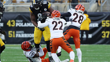 Nov 16, 2025; Pittsburgh, Pennsylvania, USA; Pittsburgh Steelers tight end Darnell Washington (80) runs with the ball against Cincinnati Bengals cornerback Dax Hill (23) and safety Geno Stone (22) during the second half at Acrisure Stadium. Mandatory Credit: Charles LeClaire-Imagn Images