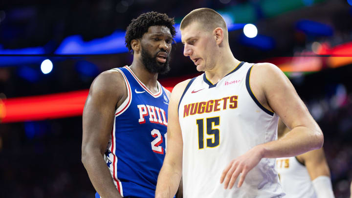 Jan 16, 2024; Philadelphia, Pennsylvania, USA; Philadelphia 76ers center Joel Embiid (21) glances at Denver Nuggets center Nikola Jokic (15) during a break in action in the third quarter at Wells Fargo Center. Mandatory Credit: Bill Streicher-USA TODAY Sports