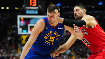 Nov 4, 2023; Denver, Colorado, USA; Denver Nuggets center Nikola Jokic (15) drives past Chicago Bulls center Nikola Vucevic (9) in the second half at Ball Arena.