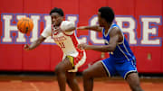 Hillcrest High's PJ Jones (11) and Vestavia Hills forward Josh Milner (14) try to grab a loose ball at Hillcrest High School Tuesday, Dec. 10, 2024.