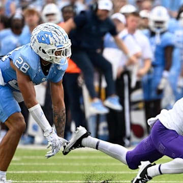Sep 21, 2024; Chapel Hill, North Carolina, USA; James Madison Dukes wide receiver Cam Ross (1) catches a long pass as North Carolina Tar Heels defensive back Alijah Huzzie (28) defends in the second quarter at Kenan Memorial Stadium. Mandatory Credit: Bob Donnan-Imagn Images