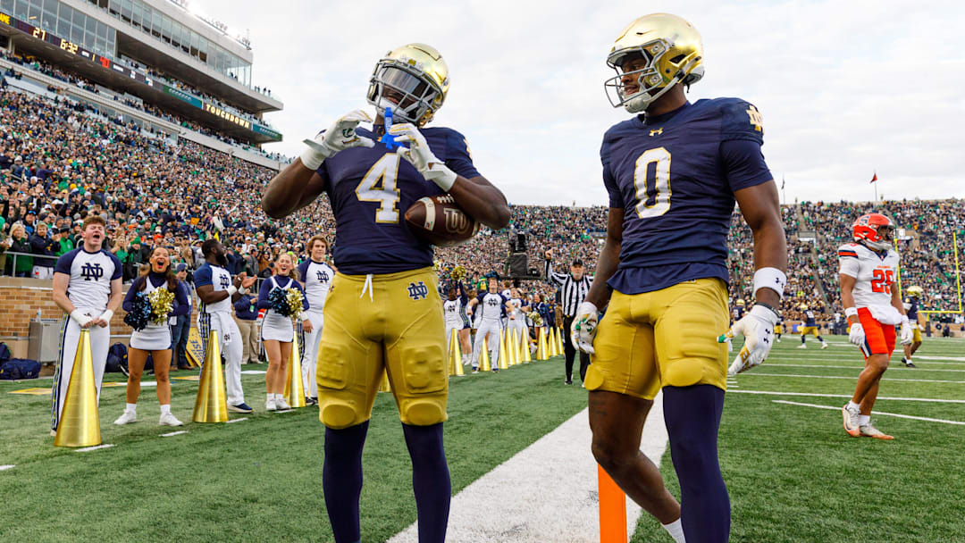 Notre Dame running back Jeremiyah Love (4) makes a heart sign after scoring a touchdown in the first half of a NCAA football game against Syracuse at Notre Dame Stadium. Notre Dame running back Jeremiyah Love (4) makes a heart sign after scoring a touchdown in the first half of a NCAA football game against Syracuse at Notre Dame Stadium.