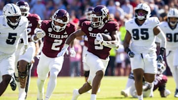Nov 22, 2025; College Station, Texas, USA; Texas A&M Aggies running back Amari Daniels (5) runs with the ball in the first half of a game against the Samford Bulldogs at Kyle Field. Mandatory Credit: Joseph Buvid-Imagn Images