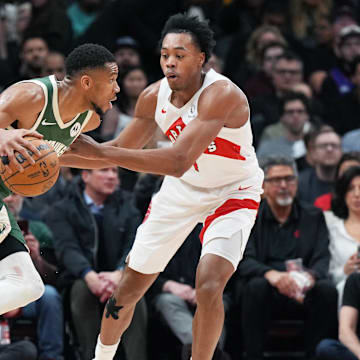 Jan 6, 2025; Toronto, Ontario, CAN; Milwaukee Bucks forward Giannis Antetokounmpo (34) controls the ball as Toronto Raptors forward Scottie Barnes (4) defends during the third quarter at Scotiabank Arena. Mandatory Credit: Nick Turchiaro-Imagn Images