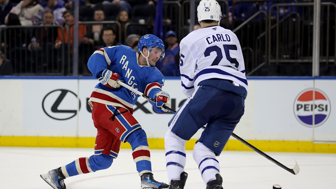 Mar 5, 2026; New York, New York, USA; New York Rangers left wing Alexis Lafreniere (13) takes a shot against Toronto Maple Leafs defenseman Brandon Carlo (25) during the second period at Madison Square Garden. Mandatory Credit: Brad Penner-Imagn Images