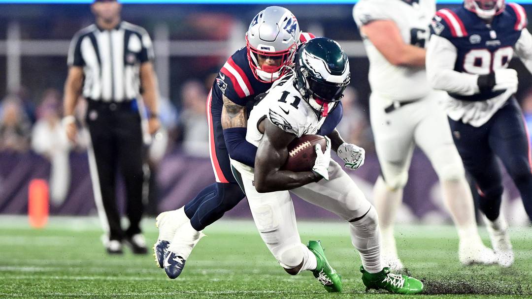Sep 10, 2023; Foxborough, Massachusetts, USA; Philadelphia Eagles wide receiver A.J. Brown (11) is tackled by New England Patriots cornerback Christian Gonzalez (6) during the second half at Gillette Stadium. Mandatory Credit: Brian Fluharty-Imagn Images