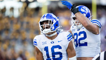 Nov 23, 2024; Tempe, Arizona, USA; Brigham Young Cougars linebacker Isaiah Glasker (16) celebrates a play with defensive end Tyler Batty (92) against the Arizona State Sun Devils at Mountain America Stadium. Mandatory Credit: Mark J. Rebilas-Imagn Images