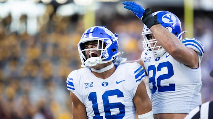 Nov 23, 2024; Tempe, Arizona, USA; Brigham Young Cougars linebacker Isaiah Glasker (16) celebrates a play with defensive end Tyler Batty (92) against the Arizona State Sun Devils at Mountain America Stadium. Mandatory Credit: Mark J. Rebilas-Imagn Images Nov 23, 2024; Tempe, Arizona, USA; Brigham Young Cougars linebacker Isaiah Glasker (16) celebrates a play with defensive end Tyler Batty (92) against the Arizona State Sun Devils at Mountain America Stadium. Mandatory Credit: Mark J. Rebilas-Imagn Images