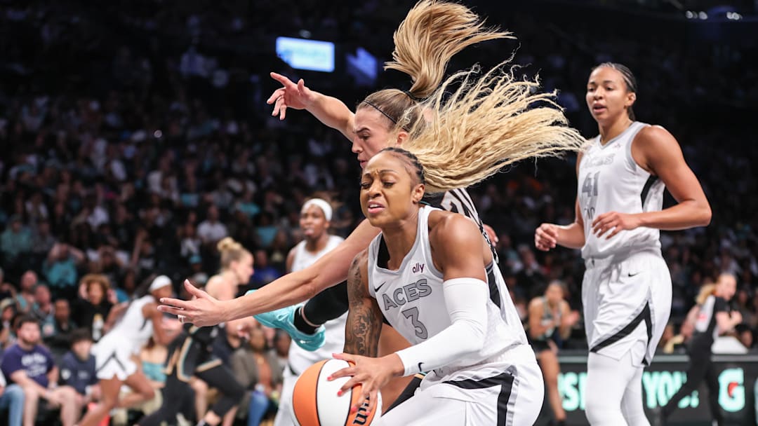May 17, 2025; Brooklyn, New York, USA;  New York Liberty guard Sabrina Ionescu (20) and Las Vegas Aces guard Tiffany Mitchell (3) fight for a loose ball in the third quarter at Barclays Center. Mandatory Credit: Wendell Cruz-Imagn Images