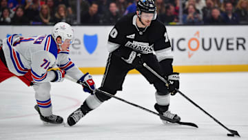 Mar 25, 2025; Los Angeles, California, USA; Los Angeles Kings left wing Tanner Jeannot (10) moves the puck against New York Rangers center Juuso Parssinen (71) during the second period at Crypto.com Arena. Mandatory Credit: Gary A. Vasquez-Imagn Images