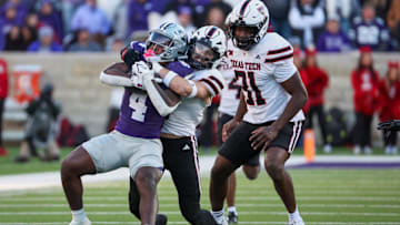 Kansas State Wildcats running back Joe Jackson is tackled by Texas Tech Red Raiders linebacker John Curry 