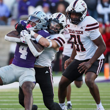Kansas State Wildcats running back Joe Jackson is tackled by Texas Tech Red Raiders linebacker John Curry 