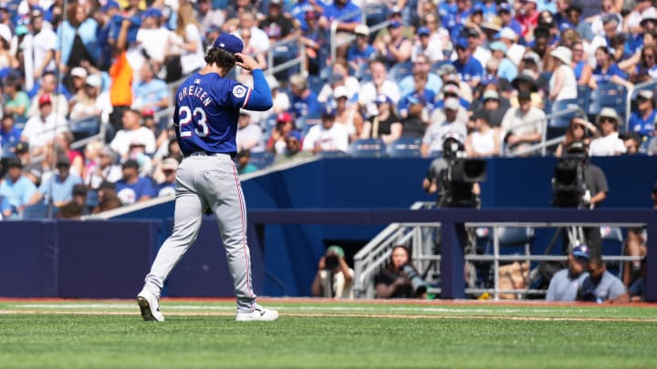 Jul 27, 2024; Toronto, Ontario, CAN; Texas Rangers starting pitcher Michael Lorenzen (23) walks towards the dugout after being relieved against the Toronto Blue Jays during the first inning at Rogers Centre. Mandatory Credit: Nick Turchiaro-USA TODAY Sports