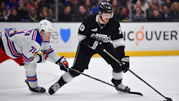 Mar 25, 2025; Los Angeles, California, USA; Los Angeles Kings left wing Tanner Jeannot (10) moves the puck against New York Rangers center Juuso Parssinen (71) during the second period at Crypto.com Arena. Mandatory Credit: Gary A. Vasquez-Imagn Images