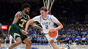 Dec 17, 2024; Durham, North Carolina, USA; Duke basketball forward Cooper Flagg (2) drives to the basket as George Mason Patriots forward Zach Anderson (10) defends during the first half at Cameron Indoor Stadium. 