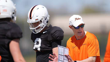 Oklahoma State quarterbacks coach Kevin Johns runs drills with the quarterbacks during a Spring football practice at Oklahoma State University in Stillwater, Okla., Tuesday, April, 8, 2025.