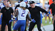 Boise State head coach Spencer Danielson celebrates with running back Ashton Jeanty.