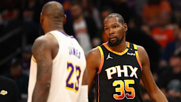 Nov 26, 2024; Phoenix, Arizona, USA; Phoenix Suns forward Kevin Durant (35) looks at Los Angeles Lakers forward LeBron James (23) during the third quarter at Footprint Center.