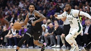 Mar 13, 2023; Sacramento, California, USA; Sacramento Kings shooting guard Malik Monk (0) moves in against Milwaukee Bucks power forward Jae Crowder (99) during the first quarter at Golden 1 Center. Mandatory Credit: Kelley L Cox-Imagn Images