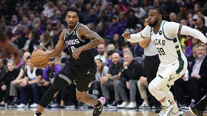 Mar 13, 2023; Sacramento, California, USA; Sacramento Kings shooting guard Malik Monk (0) moves in against Milwaukee Bucks power forward Jae Crowder (99) during the first quarter at Golden 1 Center. Mandatory Credit: Kelley L Cox-Imagn Images