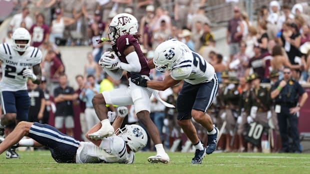 Sep 6, 2025; College Station, Texas, USA; Utah State Aggies attempts to tackle Texas A&M Aggies wide receiver Mario Craver.