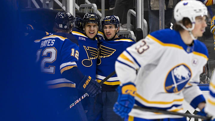 Nov 30, 2023; St. Louis, Missouri, USA;  St. Louis Blues center Brayden Schenn (10) is congratulated by right wing Kevin Hayes (12) and center Jordan Kyrou (25) after scoring against the Buffalo Sabres during the second period at Enterprise Center. Mandatory Credit: Jeff Curry-Imagn Images
