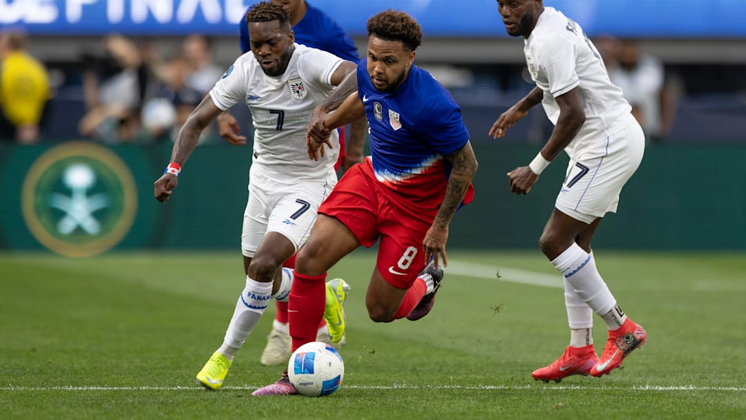 Weston McKennie dribbles away from defenders during the USMNT's Nations League semifinal game against Panama in March 2025.