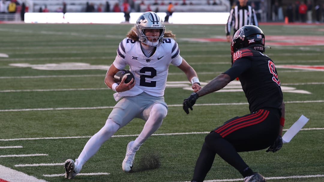 Kansas State quarterback Avery Johnson tuns against Utah linebacker Levani Damuni in Saturday's game in Salt Lake City.