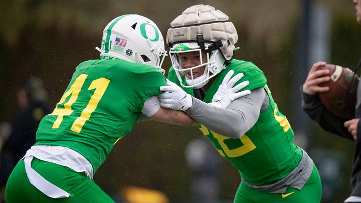 Oregon inside linebacker Devon Jackson, right, squares off against defensive back Zach Grisham during practice with the Oregon Ducks Thursday, April 4, 2024, at the Hatfield-Dowlin Complex in Eugene, Ore.