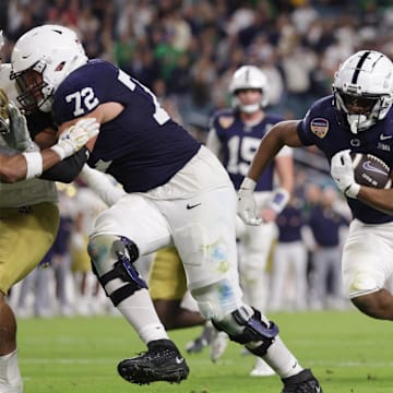 Penn State Nittany Lions running back Nicholas Singleton (10) runs the ball in the second half against the Notre Dame Fighting Irish in the Orange Bowl at Hard Rock Stadium.