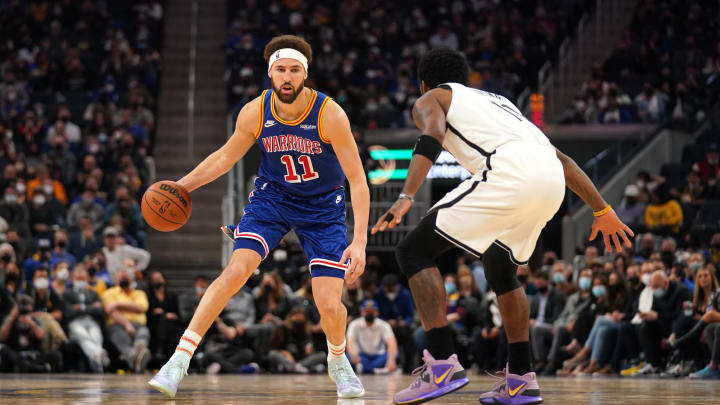 Jan 29, 2022; San Francisco, California, USA; Golden State Warriors guard Klay Thompson (11) dribbles the ball against Brooklyn Nets guard Kyrie Irving (11) in the second quarter at the Chase Center. 