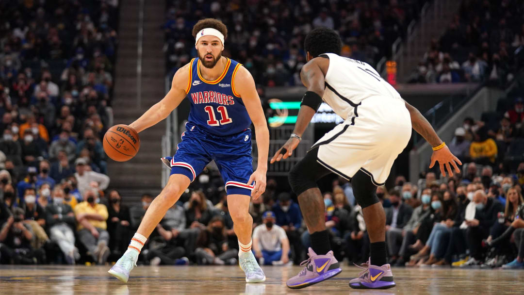 Jan 29, 2022; San Francisco, California, USA; Golden State Warriors guard Klay Thompson (11) dribbles the ball against Brooklyn Nets guard Kyrie Irving (11) in the second quarter at the Chase Center. Mandatory Credit: Cary Edmondson-USA TODAY Sports