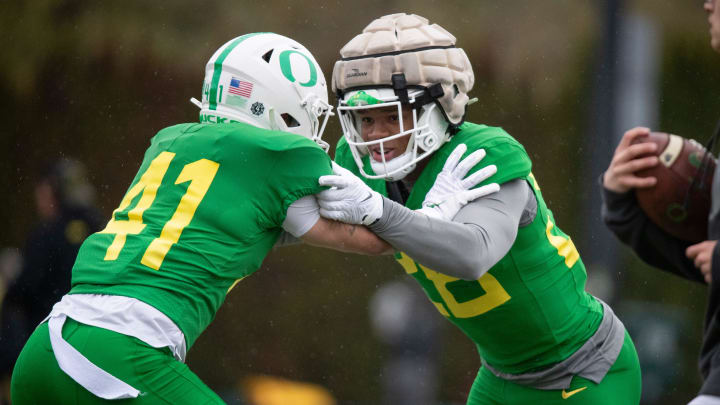 Oregon inside linebacker Devon Jackson, right, squares off against defensive back Zach Grisham during practice with the Oregon Ducks Thursday, April 4, 2024, at the Hatfield-Dowlin Complex in Eugene, Ore.