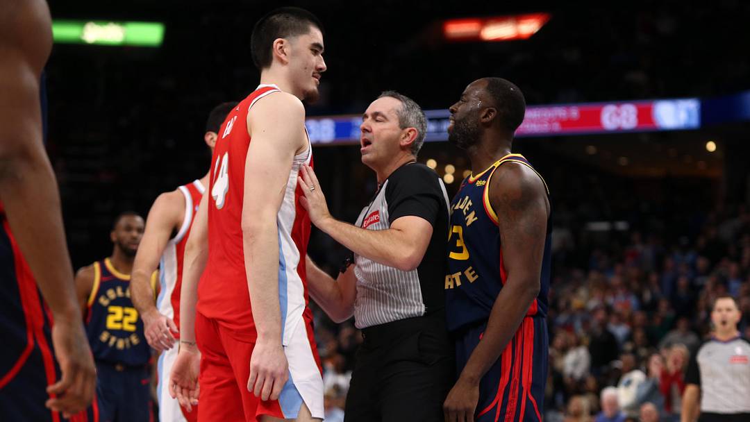 Dec 19, 2024; Memphis, Tennessee, USA; Memphis Grizzlies center Zach Edey (14) and Golden State Warriors forward Draymond Green (23) are separated by an official during the second quarter at FedExForum. 