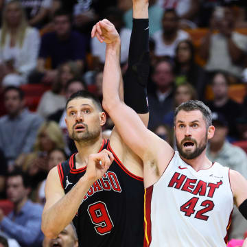 Apr 19, 2024; Miami, Florida, USA; Miami Heat forward Kevin Love (42) watches his shot against Chicago Bulls center Nikola Vucevic (9) in the fourth quarter during a play-in game of the 2024 NBA playoffs at Kaseya Center. Mandatory Credit: Sam Navarro-USA TODAY Sports