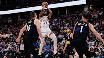 Mar 27, 2024; Denver, Colorado, USA; Phoenix Suns forward Kevin Durant (35) attempts a shot against Nikola Jokic (15)