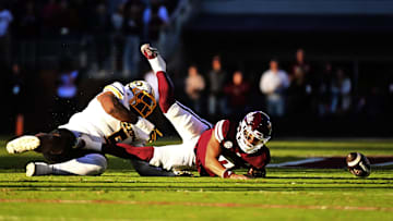 Nov 23, 2024; Starkville, Mississippi, USA; Mississippi State Bulldogs quarterback Michael Van Buren Jr. (0) fumbles as he is sacked by Missouri Tigers defensive tackle Kristian Williams (5) during the first quarter at Davis Wade Stadium at Scott Field. Mandatory Credit: Matt Bush-Imagn Images