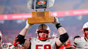 Nebraska offensive lineman Henry Lutovsky holds up the Battle Sports Kansas City Classic trophy after defeating Cincinnati at Arrowhead Stadium. 