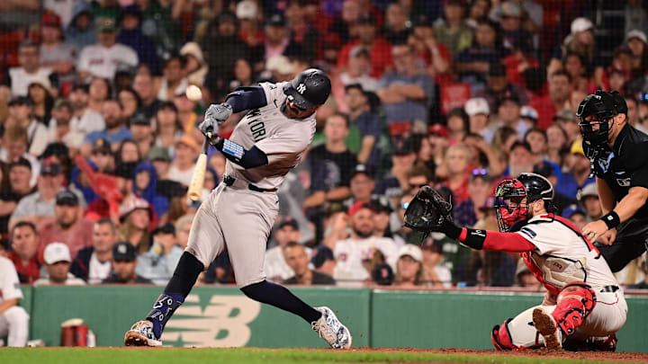 Jul 28, 2024; Boston, Massachusetts, USA; New York Yankees catcher Austin Wells (28) hits an RBI single against the Boston Red Sox during the seventh inning at Fenway Park. 