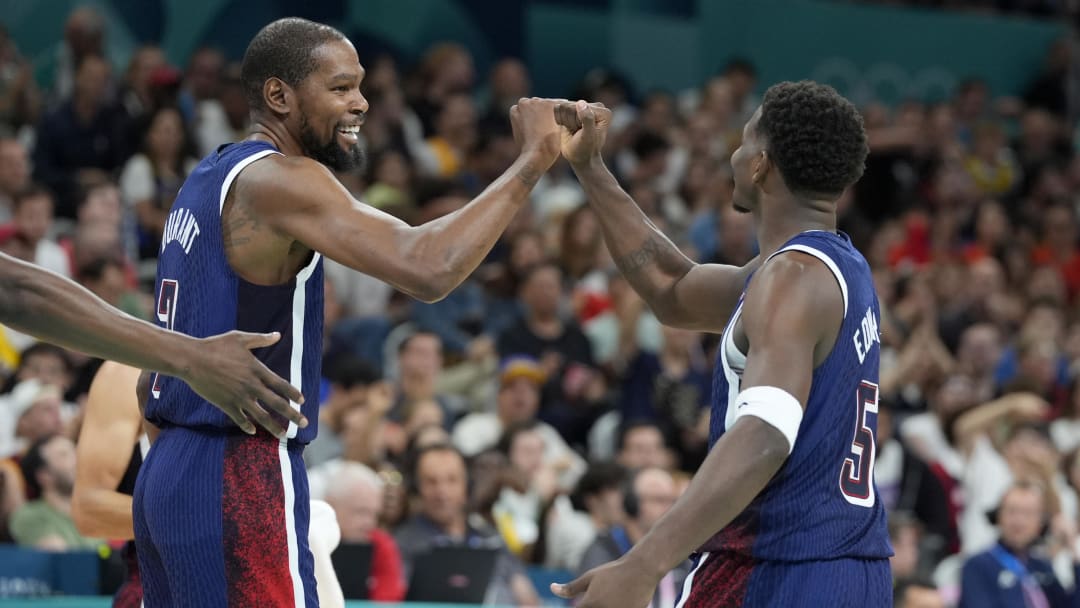 Jul 28, 2024; Villeneuve-d'Ascq, France; United States guard Kevin Durant (7) and guard Anthony Edwards (5) celebrate after a play  in the third quarter against Serbia during the Paris 2024 Olympic Summer Games at Stade Pierre-Mauroy. Mandatory Credit: John David Mercer-USA TODAY Sports