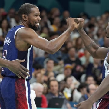 United States guard Kevin Durant (7) and guard Anthony Edwards (5) celebrate after a play  in the third quarter against Serbia during the Paris 2024 Olympic Summer Games at Stade Pierre-Mauroy in Villeneuve-d'Ascq, France, on July 28, 2024.