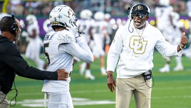 Cu football coach, deion Sanders, or coach prime, gives instructions to the large receiver Jimmy Horn Jr. (5) against CSU in Th