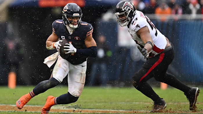 Dec 31, 2023; Chicago, Illinois, USA;  Chicago Bears quarterback Justin Fields (1) scrambles away