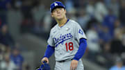 Oct 31, 2025; Toronto, Ontario, CAN; Los Angeles Dodgers pitcher Yoshinobu Yamamoto (18) reacts in the fifth inning against the Toronto Blue Jays during game six of the 2025 MLB World Series at Rogers Centre. Mandatory Credit: John E. Sokolowski-Imagn Images